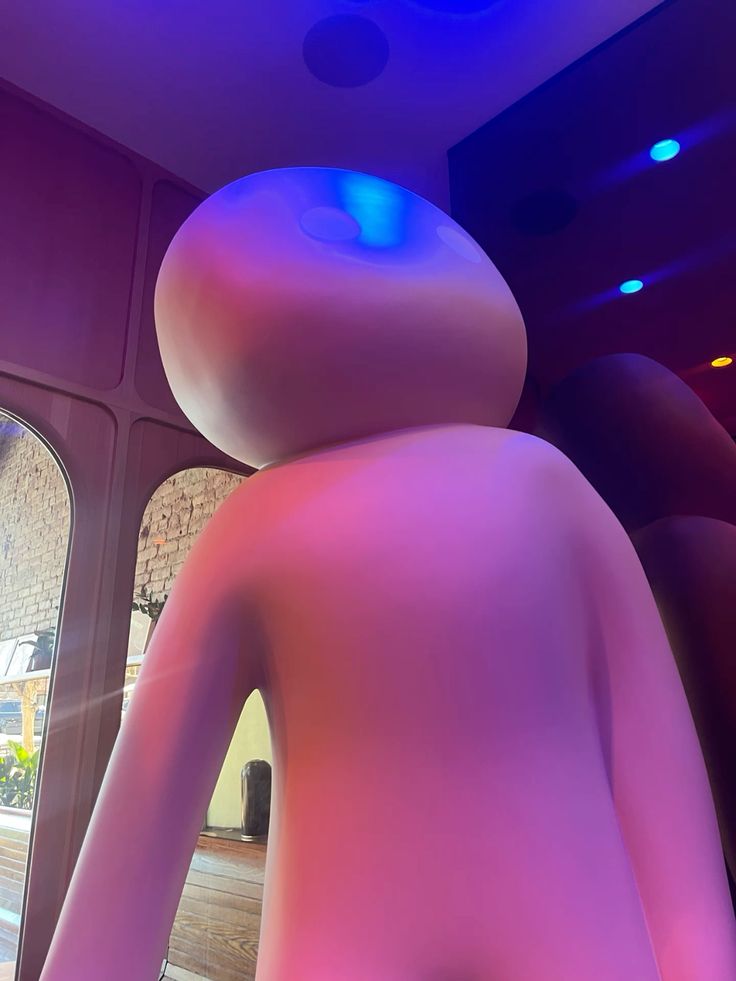 JELLYMAN mascot - a glossy pink humanoid figure